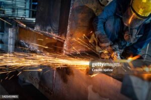 Projetos worker in protective mask welding pipe in workshop